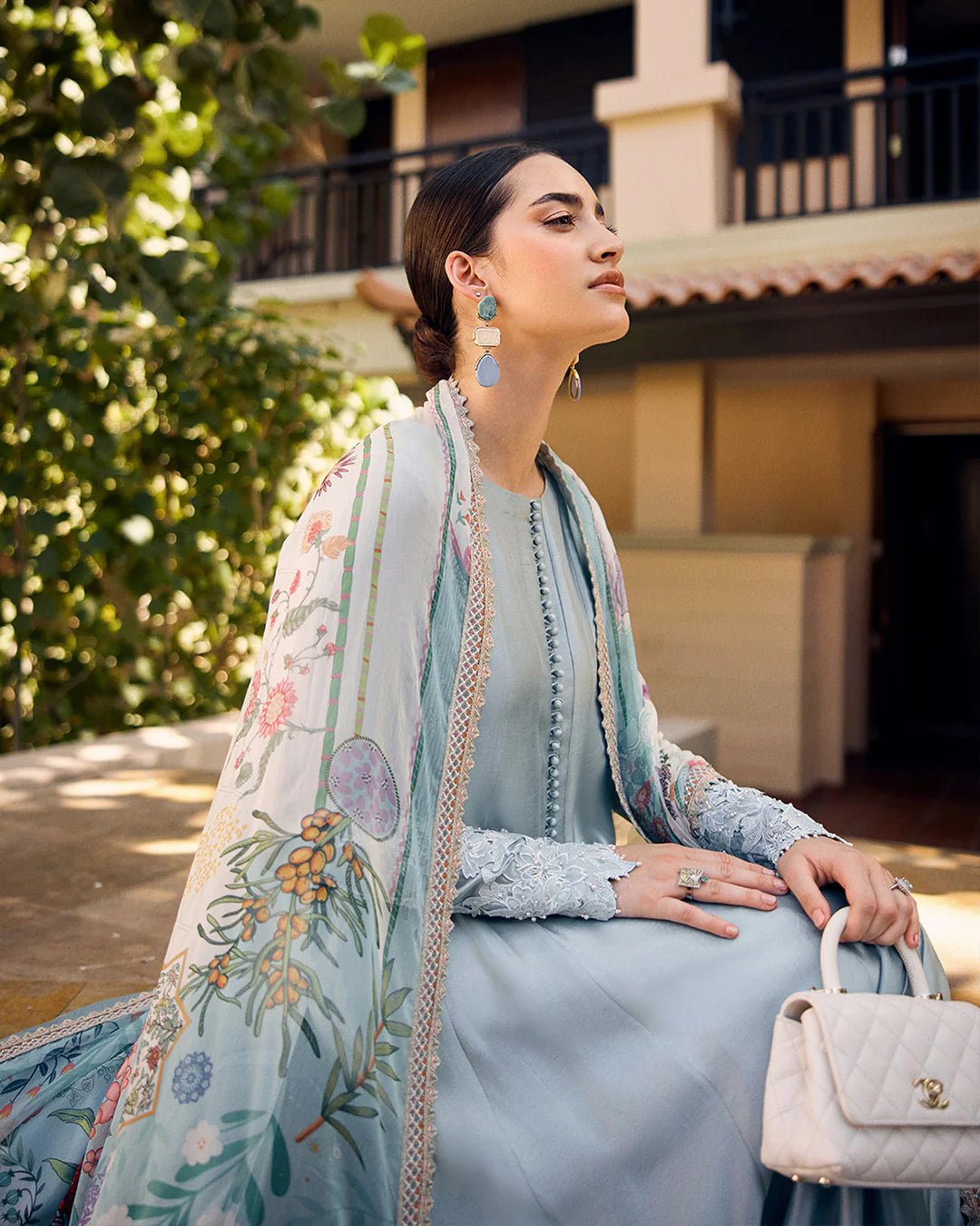 model wearing Leia light blue flowy dress with embroidered sleeves and printed dupatta from Faiza Saqlain, available in the UK. Shop Pakistani clothes online.