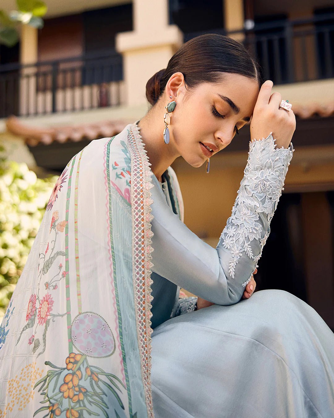 model wearing Leia light blue flowy dress with embroidered sleeves and printed dupatta from Faiza Saqlain, available in the UK. Shop Pakistani clothes online.