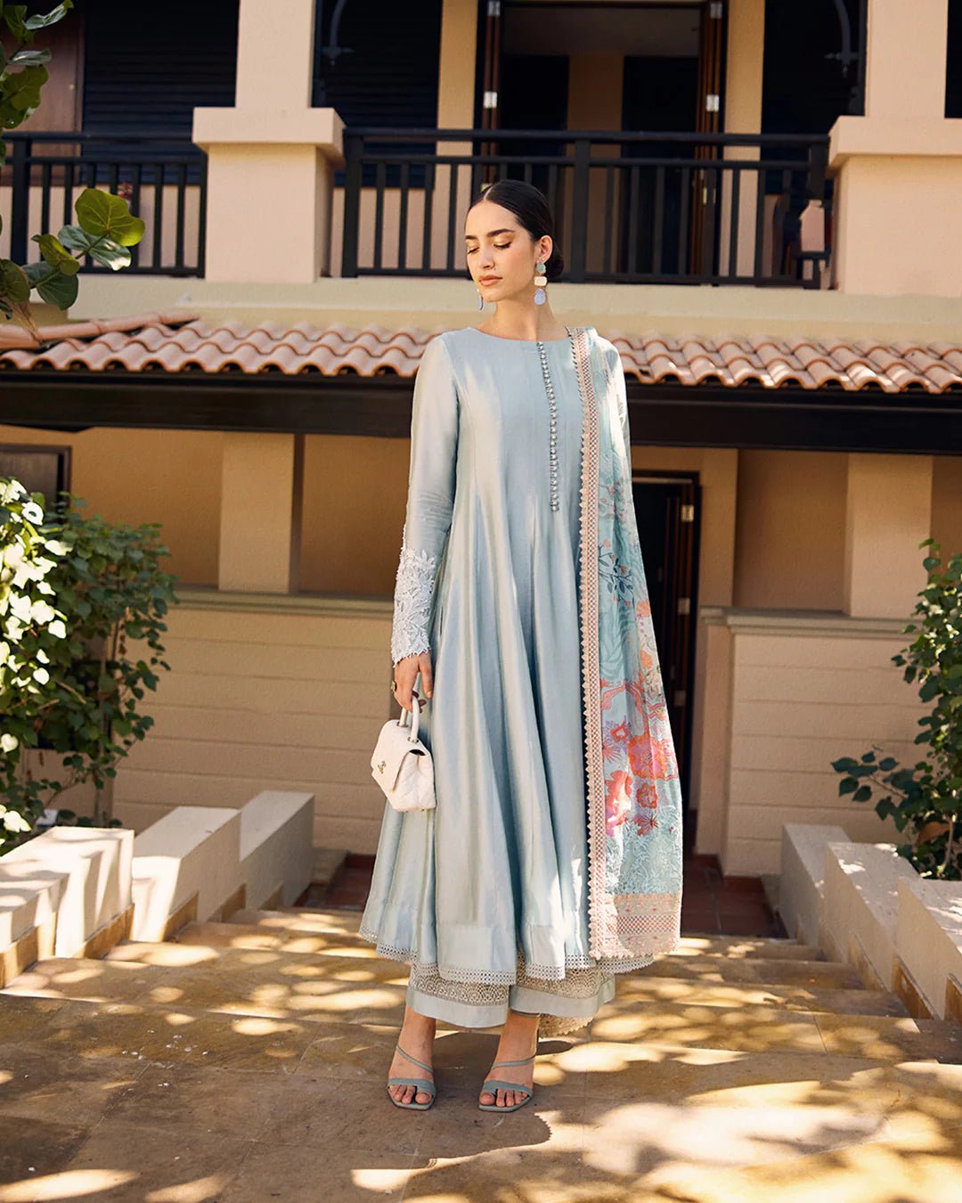 model wearing Leia light blue flowy dress with embroidered sleeves and printed dupatta from Faiza Saqlain, available in the UK. Shop Pakistani clothes online.