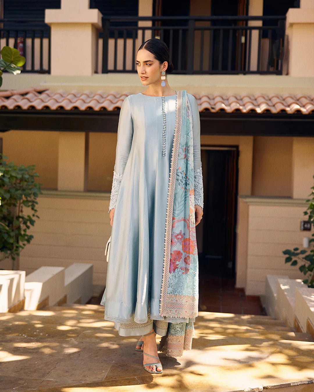 model wearing Leia light blue flowy dress with embroidered sleeves and printed dupatta from Faiza Saqlain, available in the UK. Shop Pakistani clothes online.