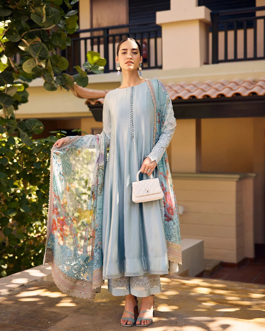 model wearing Leia light blue flowy dress with embroidered sleeves and printed dupatta from Faiza Saqlain, available in the UK. Shop Pakistani clothes online.