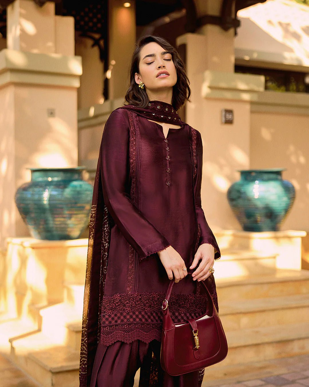 Model wearing Faiza Saqlain Carmela Triana in dark maroon with intricate embroidery, perfect for Pakistani bridal dresses online in UK.