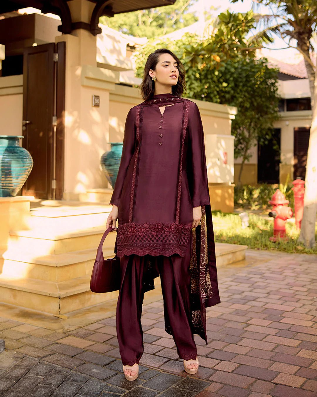 Model wearing Faiza Saqlain Carmela Triana in dark maroon with intricate embroidery, perfect for Pakistani bridal dresses online in UK.