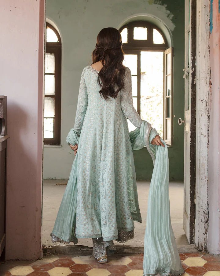 Model wearing Faiza Saqlain Naaz dress in soft blue from the Dhoop Kinaray Formals collection, perfect for weddings, available for Pakistani clothes online in the UK.