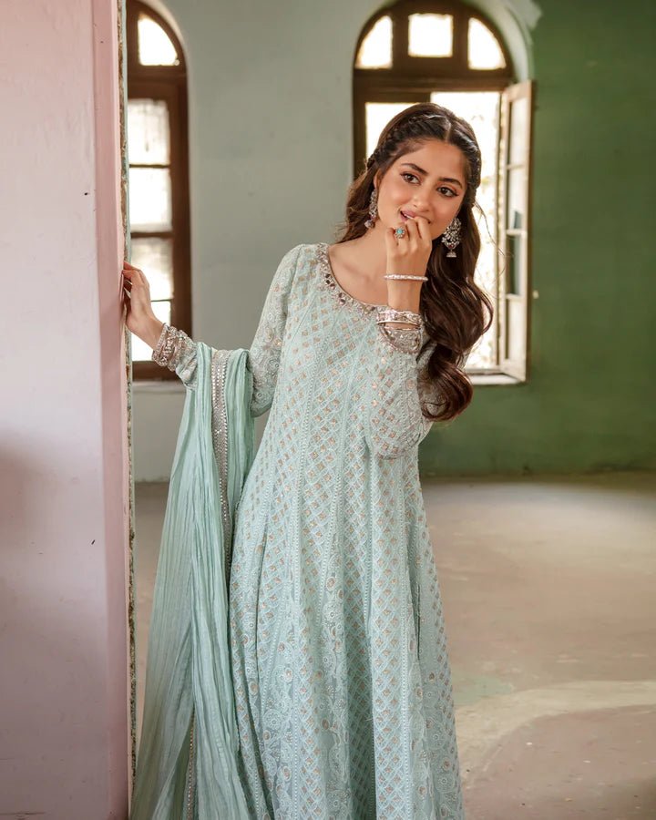 Model wearing Faiza Saqlain Naaz dress in soft blue from the Dhoop Kinaray Formals collection, perfect for weddings, available for Pakistani clothes online in the UK.