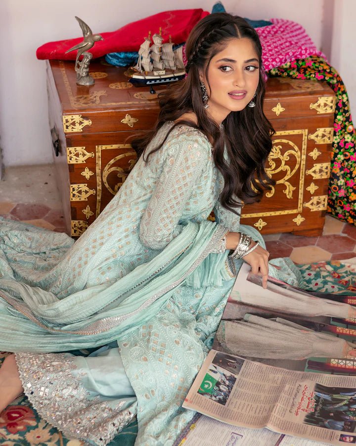 Model wearing Faiza Saqlain Naaz dress in soft blue from the Dhoop Kinaray Formals collection, perfect for weddings, available for Pakistani clothes online in the UK.