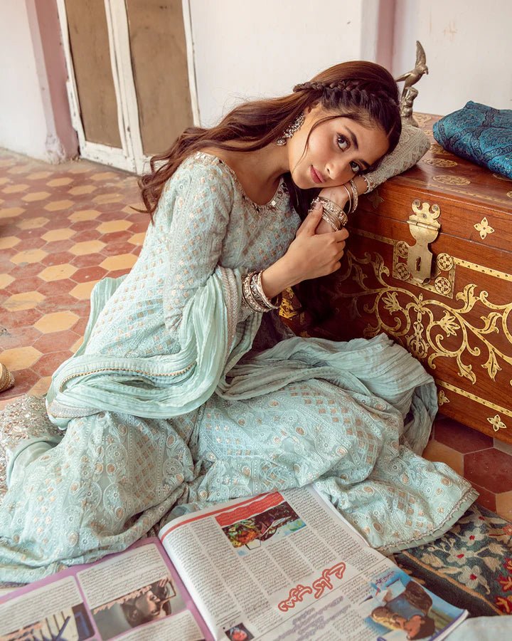 Model wearing Faiza Saqlain Naaz dress in soft blue from the Dhoop Kinaray Formals collection, perfect for weddings, available for Pakistani clothes online in the UK.