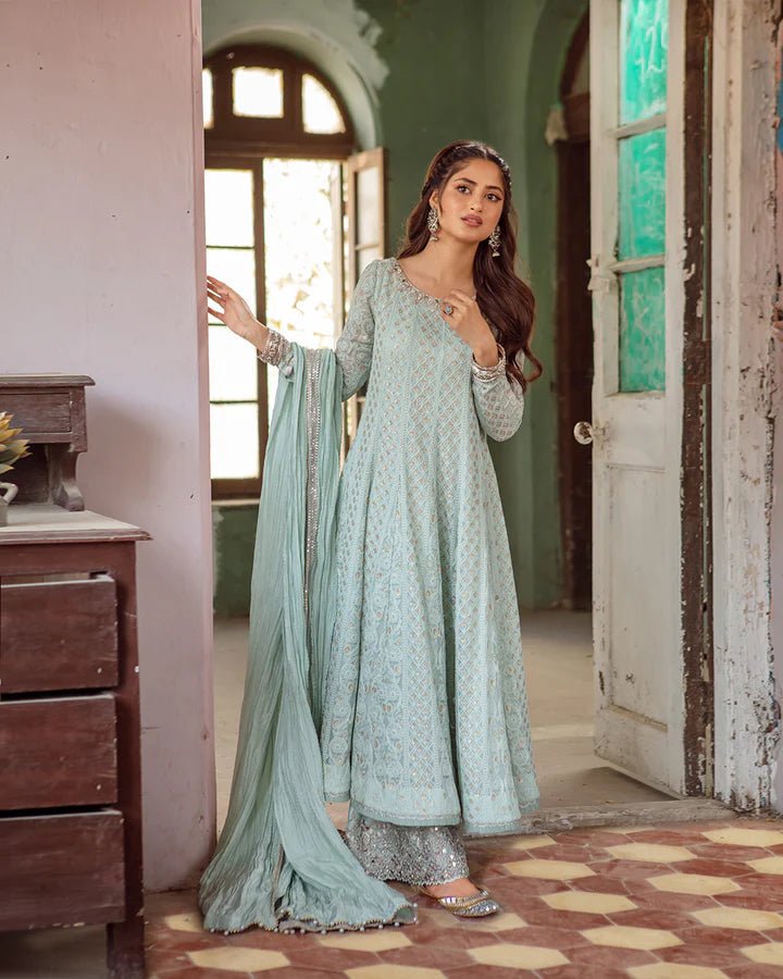 Model wearing Faiza Saqlain Naaz dress in soft blue from the Dhoop Kinaray Formals collection, perfect for weddings, available for Pakistani clothes online in the UK.