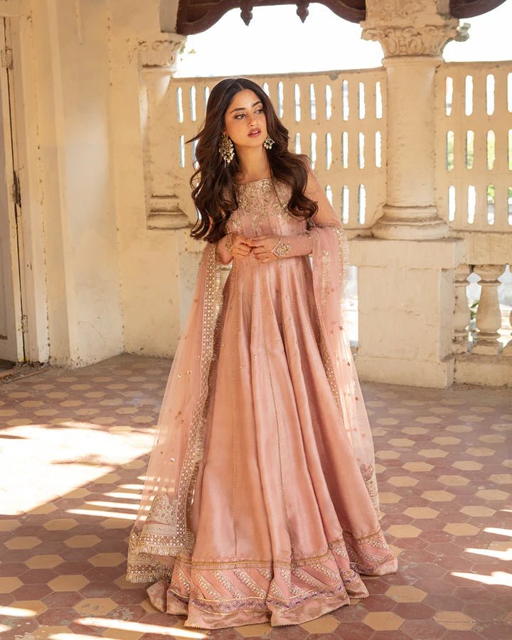 Model wearing Faiza Saqlain Nazmin dress in soft pink from the Dhoop Kinaray Formals collection, perfect for weddings, available for Pakistani clothes online in the UK.