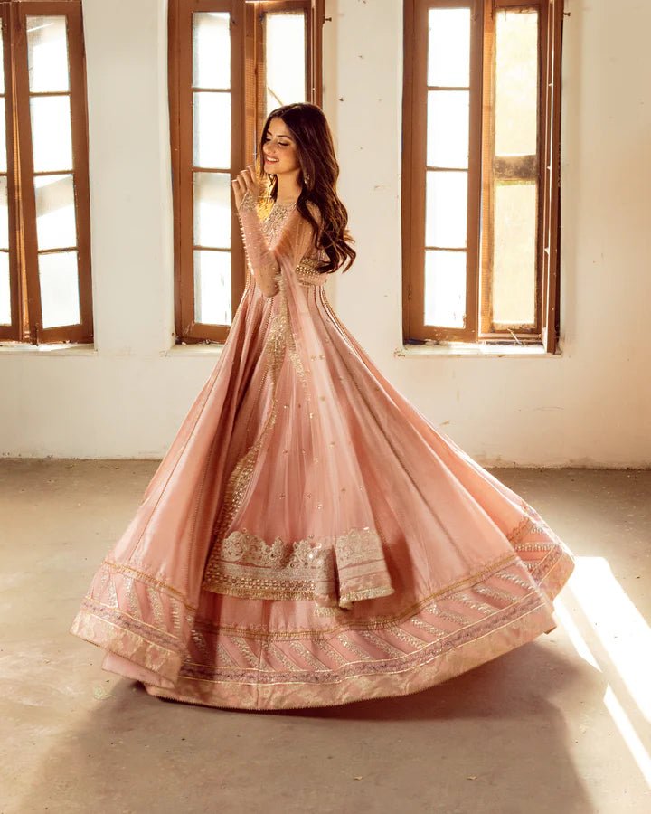 Model wearing Faiza Saqlain Nazmin dress in soft pink from the Dhoop Kinaray Formals collection, perfect for weddings, available for Pakistani clothes online in the UK.