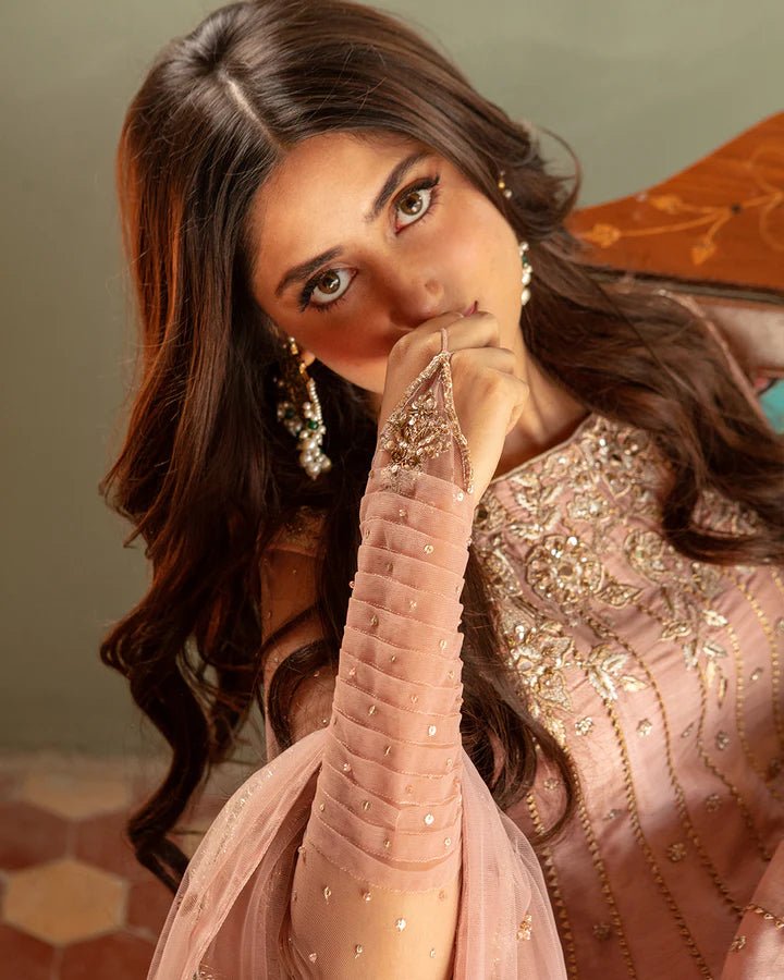 Model wearing Faiza Saqlain Nazmin dress in soft pink from the Dhoop Kinaray Formals collection, perfect for weddings, available for Pakistani clothes online in the UK.