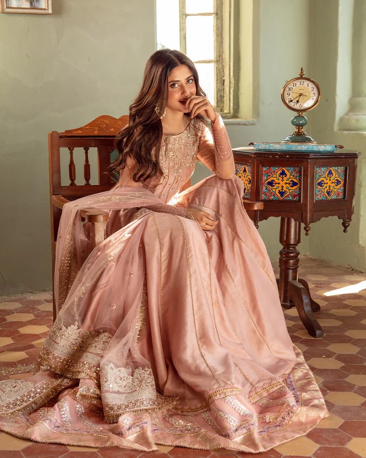 Model wearing Faiza Saqlain Nazmin dress in soft pink from the Dhoop Kinaray Formals collection, perfect for weddings, available for Pakistani clothes online in the UK.