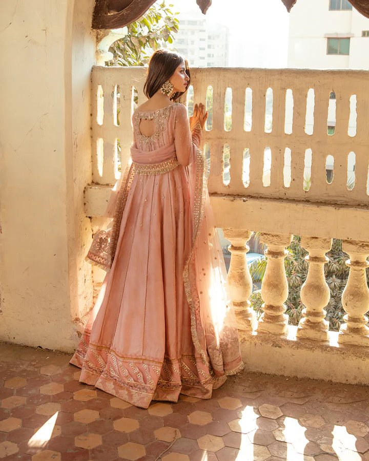 Model wearing Faiza Saqlain Nazmin dress in soft pink from the Dhoop Kinaray Formals collection, perfect for weddings, available for Pakistani clothes online in the UK.