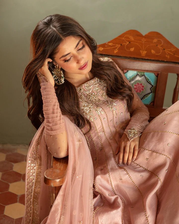 Model wearing Faiza Saqlain Nazmin dress in soft pink from the Dhoop Kinaray Formals collection, perfect for weddings, available for Pakistani clothes online in the UK.