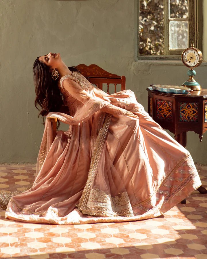 Model wearing Faiza Saqlain Nazmin dress in soft pink from the Dhoop Kinaray Formals collection, perfect for weddings, available for Pakistani clothes online in the UK.