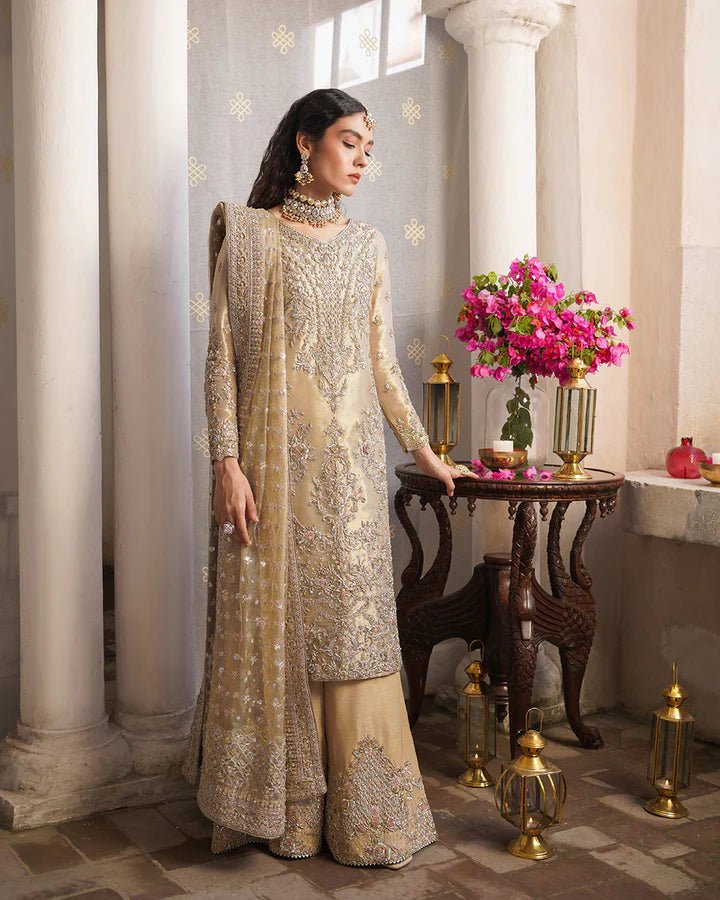 Model wearing Faiza Saqlain Formals Irina Aurela dress in Dull Gold, Pakistani clothes online in UK.