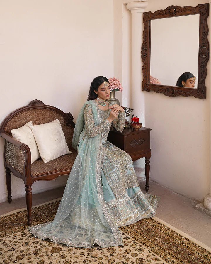 Model wearing Faiza Saqlain Formals Irina Oct '23 Cahya dress in ice - blue, showcasing Pakistani clothes online in UK.