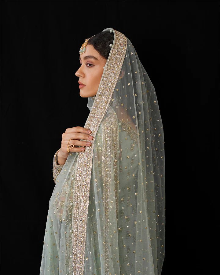 Model wearing Faiza Saqlain Formals Irina Oct '23 Cahya dress in ice - blue, showcasing Pakistani clothes online in UK.