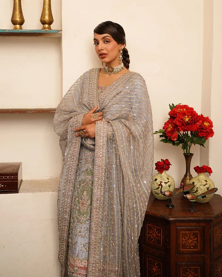 Model wearing Faiza Saqlain Formals Irina Oct '23 Edrina dress in grayish blue, Pakistani clothes online in UK.