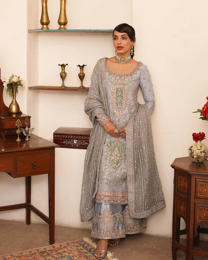 Model wearing Faiza Saqlain Formals Irina Oct '23 Edrina dress in grayish blue, Pakistani clothes online in UK.