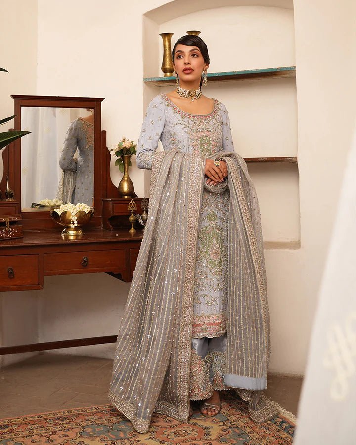 Model wearing Faiza Saqlain Formals Irina Oct '23 Edrina dress in grayish blue, Pakistani clothes online in UK.