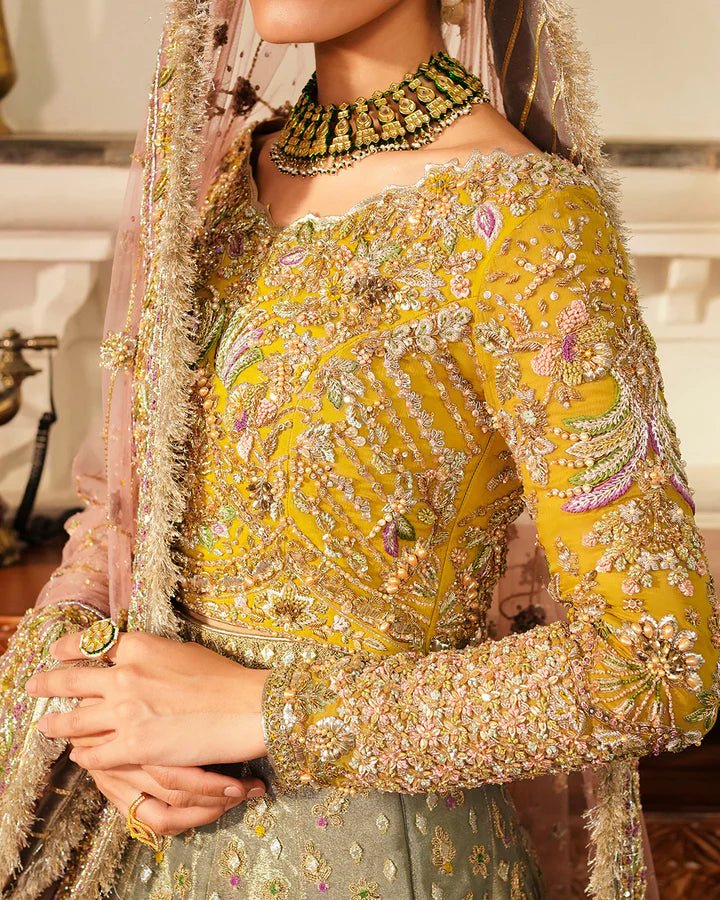 Model wearing Faiza Saqlain Formals Irina Oct '23 Najmeh dress in pastel green, yellow and blush pink, showcasing tradtional Pakistani clothes online in UK.