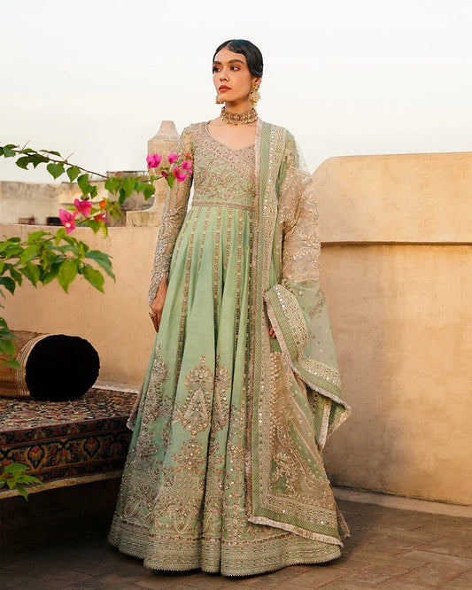 Model wearing Faiza Saqlain Formals Irina Oct '23 Adana dress in pistachio green, showingPakistani clothes online in UK.