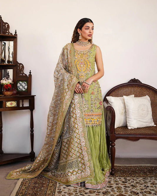 Model wearing Faiza Saqlain Formals Irina Oct '23 Tamaan dress in green, showcasing Pakistani clothes online in UK.