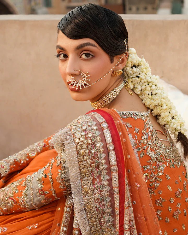 Model wearing Faiza Saqlain Formals Irina Oct '23 Sevgi dress in orange gold, Pakistani clothes online in UK.