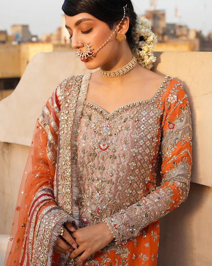 Model wearing Faiza Saqlain Formals Irina Oct '23 Sevgi dress in orange gold, Pakistani clothes online in UK.