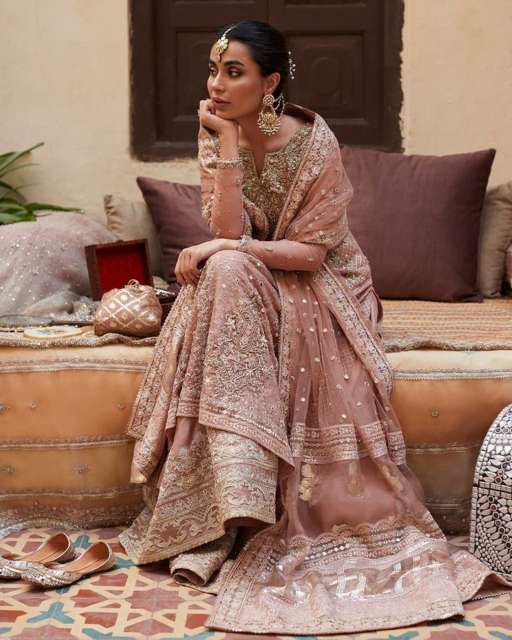 Model wearing Faiza Saqlain Formals Sanaz Zeena, a soft pink embroidered formal dress with intricate details, perfect for weddings. Available as Pakistani clothes online in the UK.