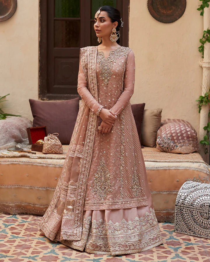 Model wearing Faiza Saqlain Formals Sanaz Zeena, a soft pink embroidered formal dress with intricate details, perfect for weddings. Available as Pakistani clothes online in the UK.