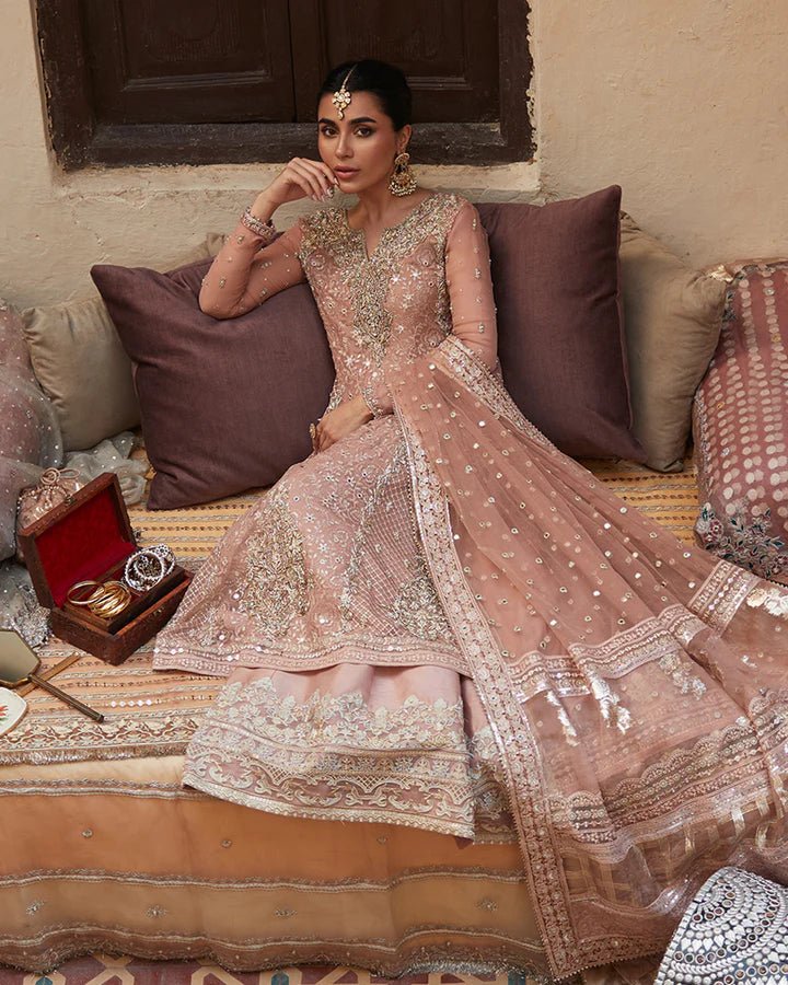 Model wearing Faiza Saqlain Formals Sanaz Zeena, a soft pink embroidered formal dress with intricate details, perfect for weddings. Available as Pakistani clothes online in the UK.