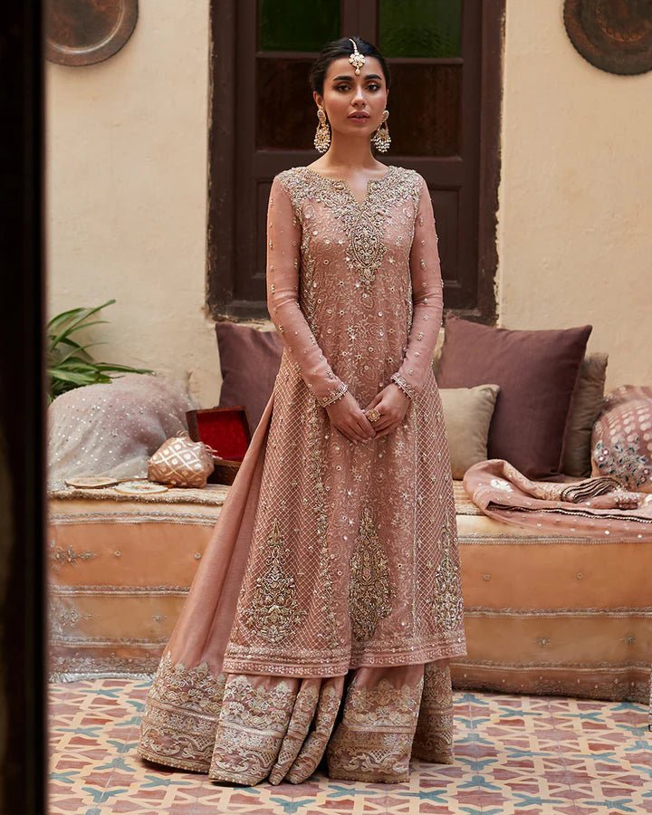 Model wearing Faiza Saqlain Formals Sanaz Zeena, a soft pink embroidered formal dress with intricate details, perfect for weddings. Available as Pakistani clothes online in the UK.