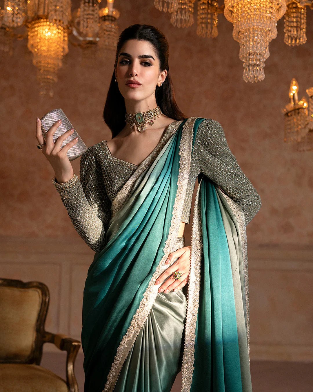 Model wearing Faiza Saqlain Ismene Velvet Ailey saree in emerald green with a silver embellished blouse. Shop Pakistani bridal dresses online in the UK now.