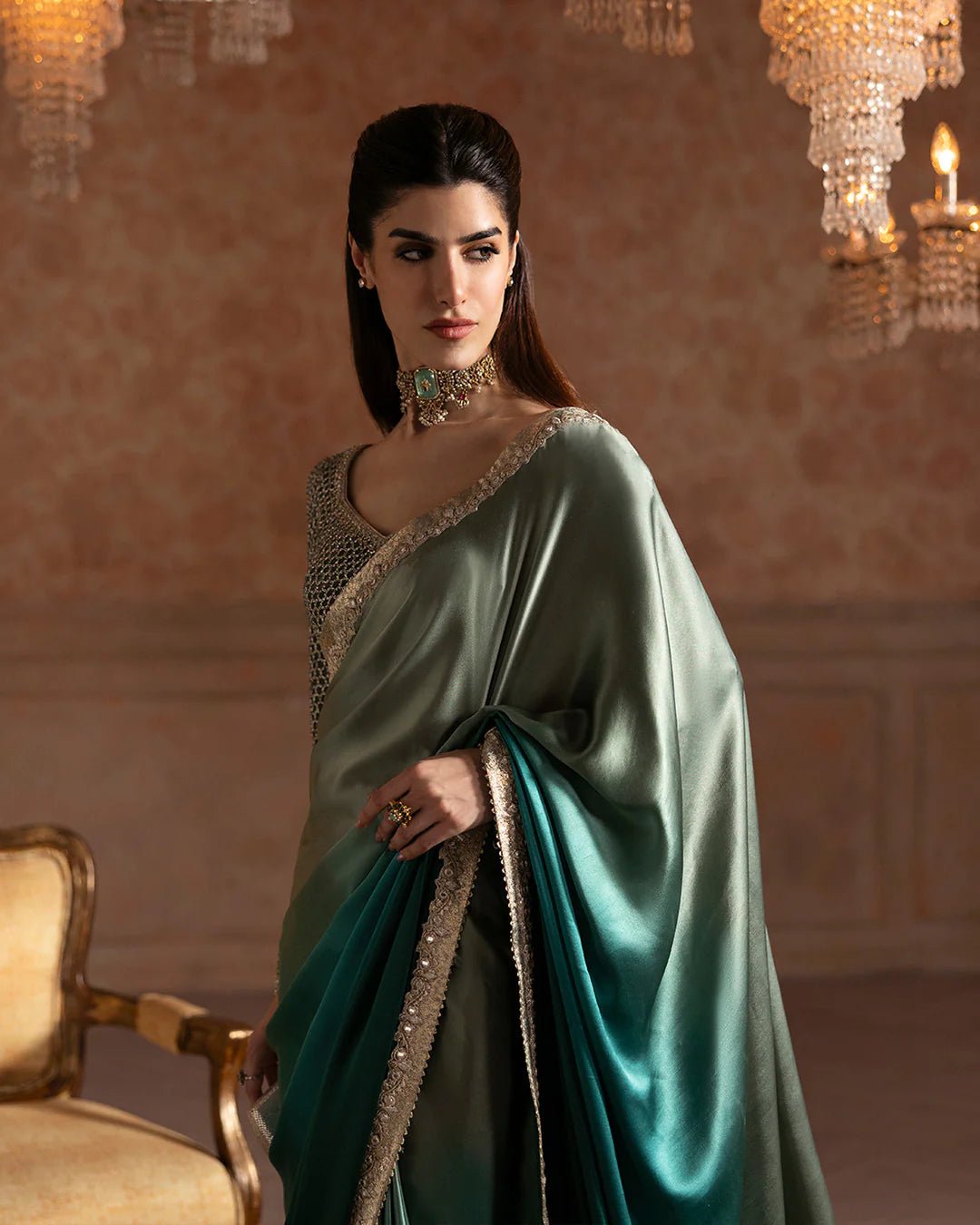 Model wearing Faiza Saqlain Ismene Velvet Ailey saree in emerald green with a silver embellished blouse. Shop Pakistani bridal dresses online in the UK now.