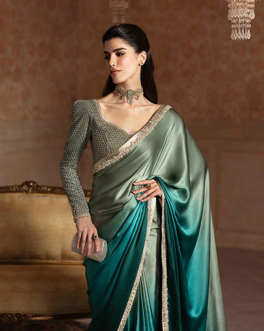 Model wearing Faiza Saqlain Ismene Velvet Ailey saree in emerald green with a silver embellished blouse. Shop Pakistani bridal dresses online in the UK now.