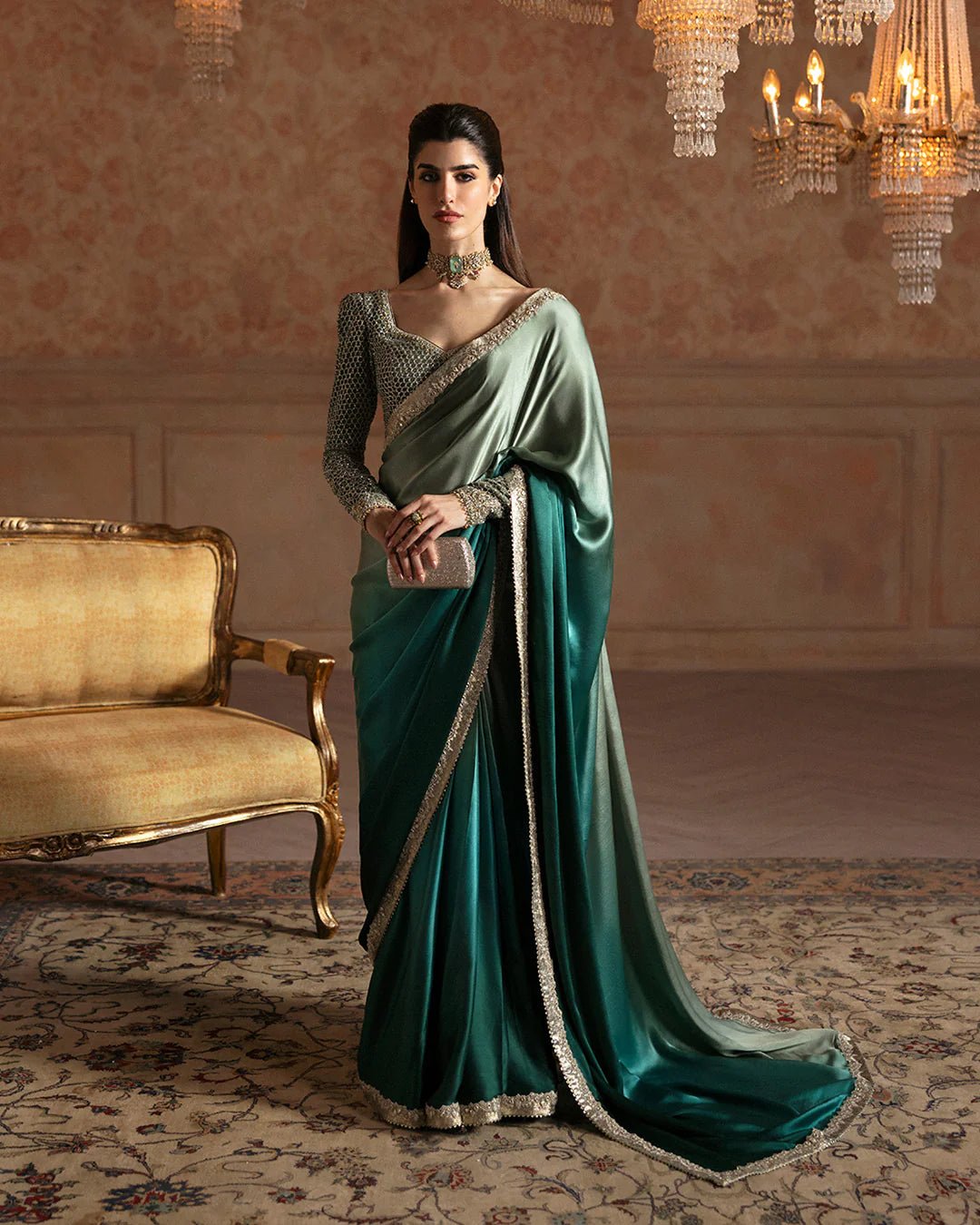 Model wearing Faiza Saqlain Ismene Velvet Ailey saree in emerald green with a silver embellished blouse. Shop Pakistani bridal dresses online in the UK now.