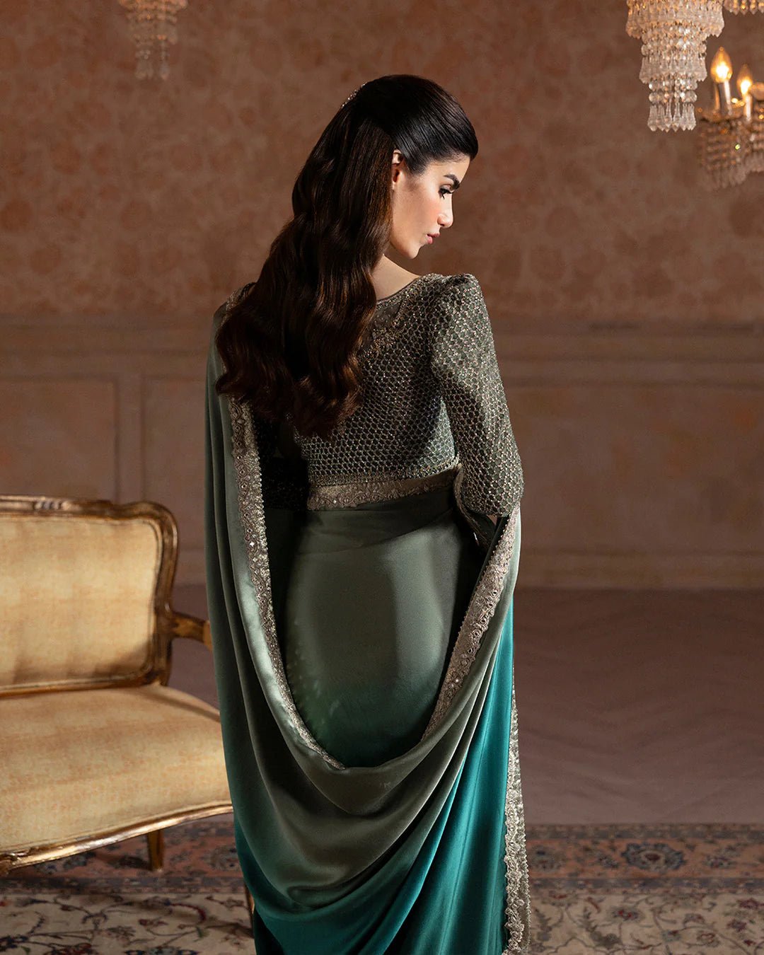 Model wearing Faiza Saqlain Ismene Velvet Ailey saree in emerald green with a silver embellished blouse. Shop Pakistani bridal dresses online in the UK now.