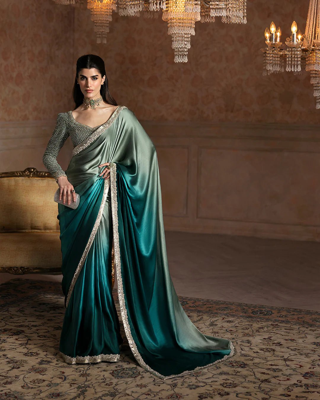 Model wearing Faiza Saqlain Ismene Velvet Ailey saree in emerald green with a silver embellished blouse. Shop Pakistani bridal dresses online in the UK now.