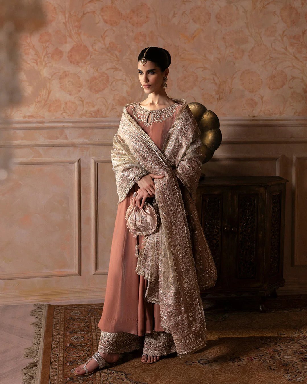 Model wearing Faiza Saqlain Ismene Averna dress in dusty rose with intricate silver embroidery and embellished dupatta. Shop Pakistani bridal dresses online in the UK now.