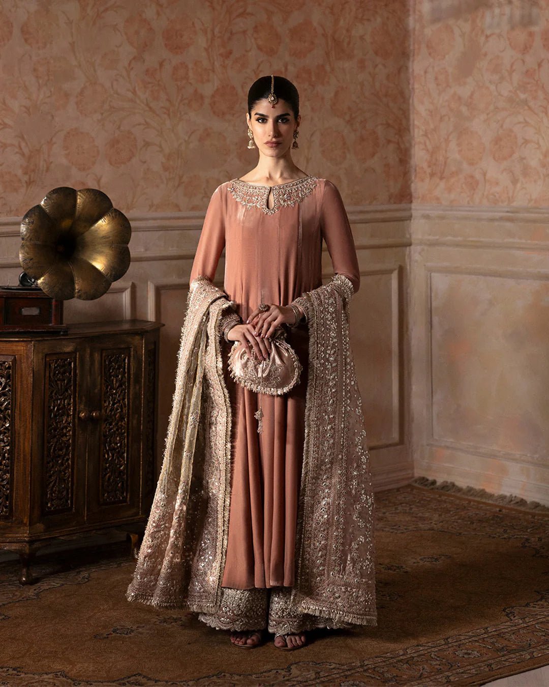 Model wearing Faiza Saqlain Ismene Averna dress in dusty rose with intricate silver embroidery and embellished dupatta. Shop Pakistani bridal dresses online in the UK now.