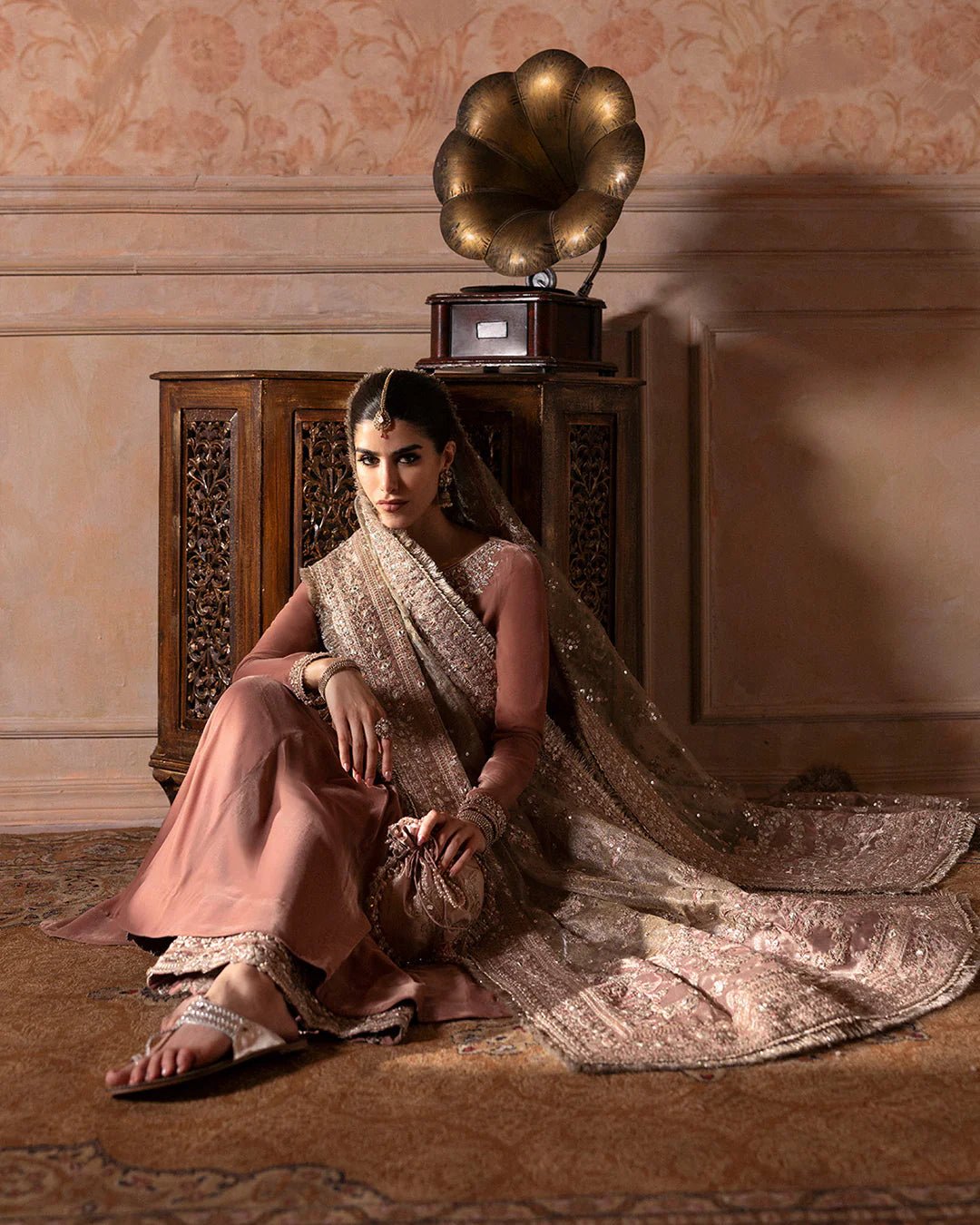 Model wearing Faiza Saqlain Ismene Averna dress in dusty rose with intricate silver embroidery and embellished dupatta. Shop Pakistani bridal dresses online in the UK now.