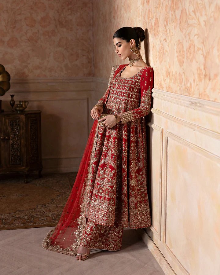 Model wearing a rich red Savina dress from Faiza Saqlain, perfect for Eid, showcasing Pakistani clothes in the UK.