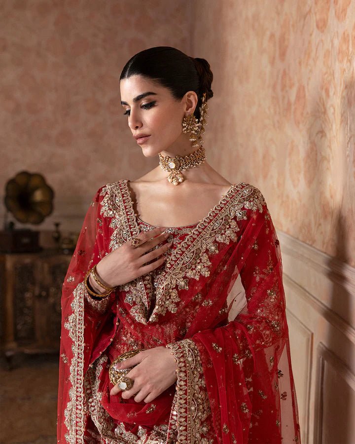 Model wearing a rich red Savina dress from Faiza Saqlain, perfect for Eid, showcasing Pakistani clothes in the UK.