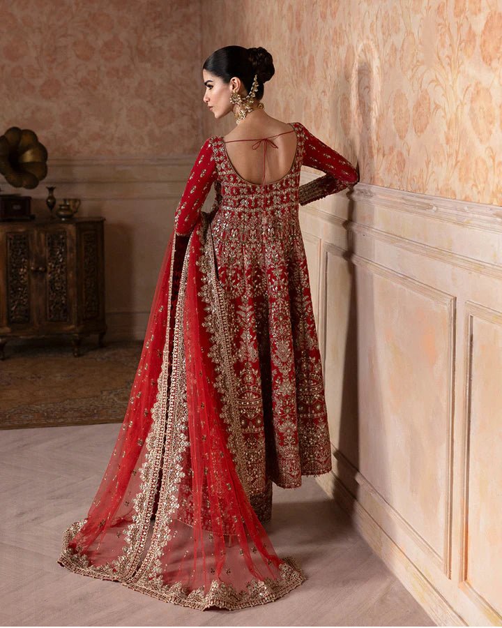 Model wearing a rich red Savina dress from Faiza Saqlain, perfect for Eid, showcasing Pakistani clothes in the UK.