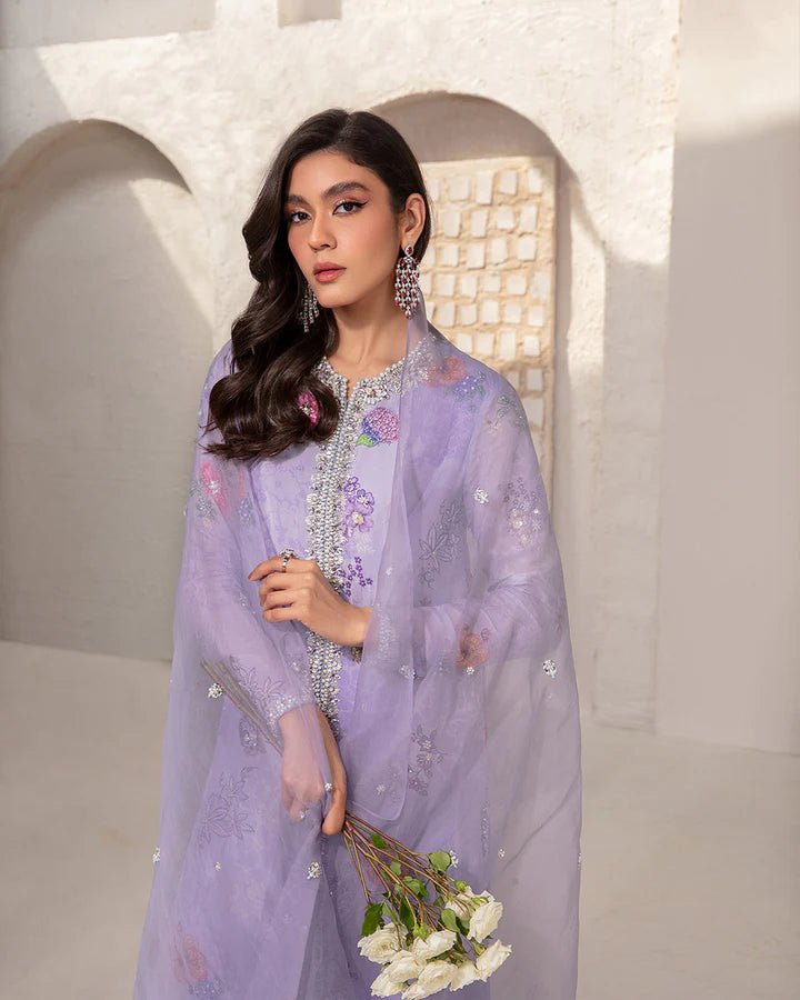 Model wearing a lavender Aria dress with intricate floral embroidery from Faiza Saqlain's Lenora Luxury Pret '24 collection. Pakistani clothes online in UK.