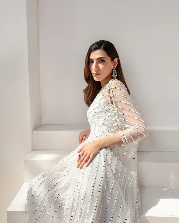 Model wearing an elegant white Ariella dress from Faiza Saqlain's Lenora Luxury Pret '24 collection. Pakistani clothes online in UK.