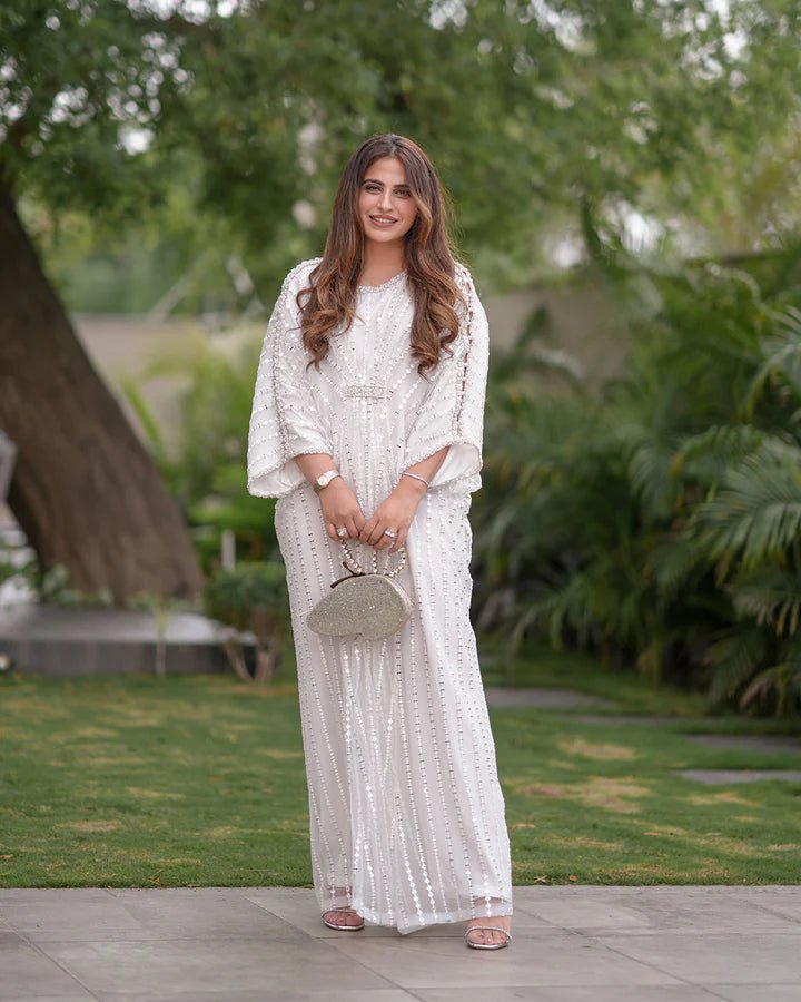 Model wearing an elegant white Ariella dress from Faiza Saqlain's Lenora Luxury Pret '24 collection. Pakistani clothes online in UK.