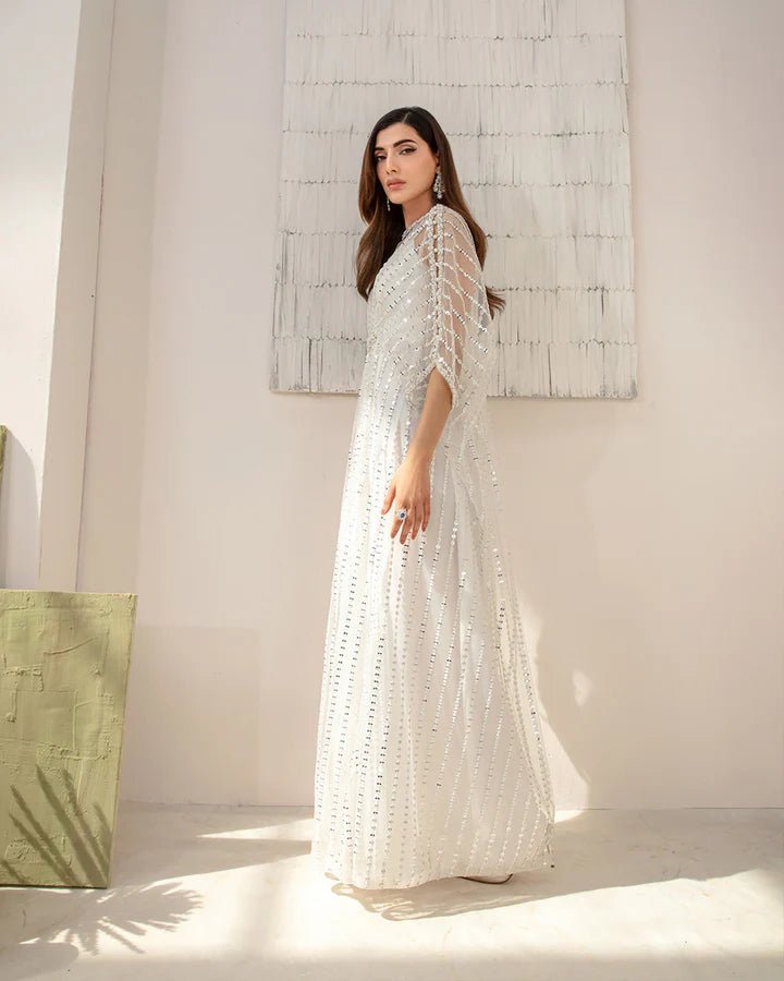 Model wearing an elegant white Ariella dress from Faiza Saqlain's Lenora Luxury Pret '24 collection. Pakistani clothes online in UK.